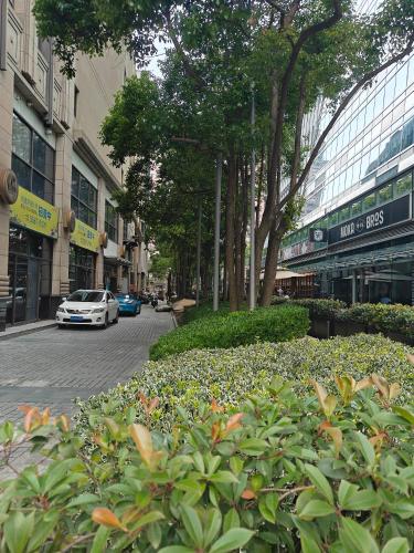 a street in a city with a car parked on the street at Atour X Hotel West Nanjing Road in Shanghai