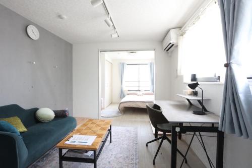 a living room with a couch and a table at Comfort Boutique Room in Tokyo