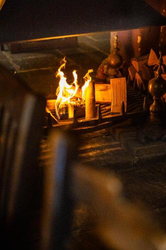 a fire in a fireplace in a room at Shibden Mill Inn in Halifax