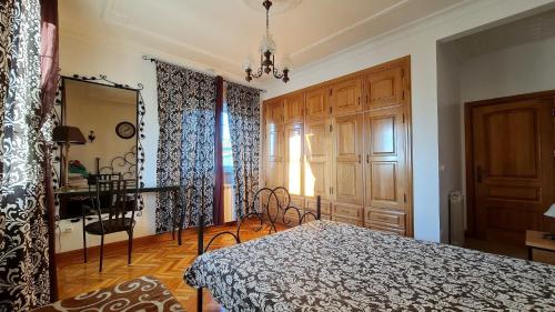 a bedroom with a bed and a table and a window at Villas de Nazare in Maceira