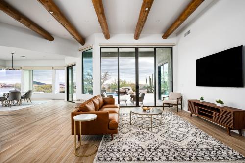 a living room with a couch and a tv at Mountain views swimming a private escape at Sonoran Serenity in Scottsdale