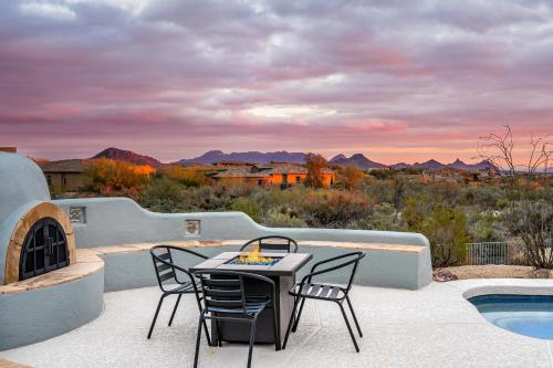 a patio with a table and chairs and a pool at Mountain views swimming a private escape at Sonoran Serenity in Scottsdale