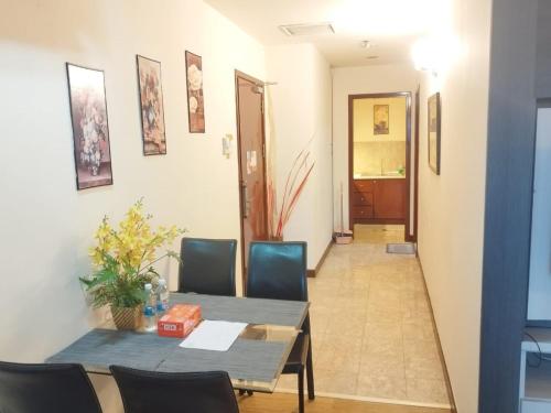 a dining room with a table and chairs and a hallway at My Residence Villa Times Square KL in Kuala Lumpur