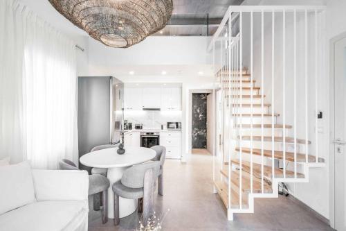 a living room with a staircase and a table and chairs at Mournia Plaka in Plaka