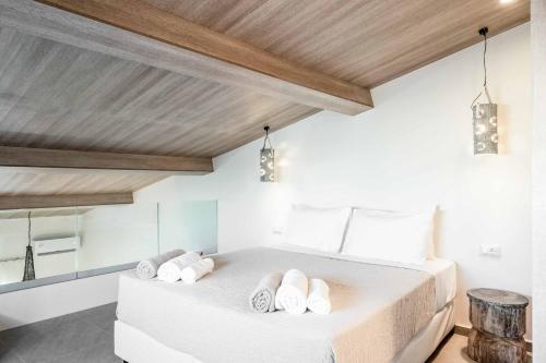a bedroom with a bed with towels on it at Mournia Plaka in Plaka