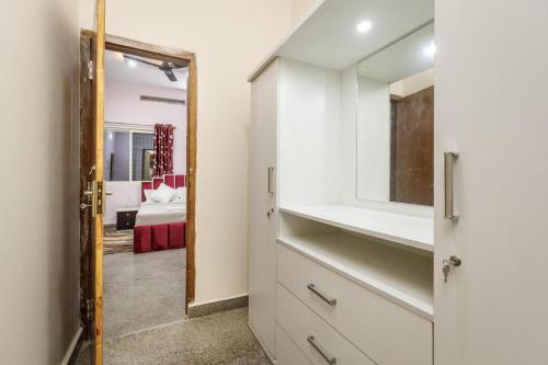 a bathroom with a sink and a mirror at Villa Exotica by StayJade5bhkPoolACProjector in Denkanikota