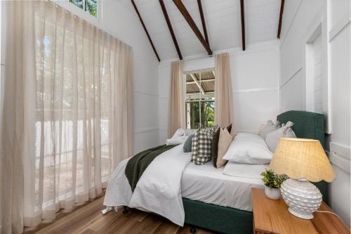 a bedroom with a bed and a window at Little Forest Alpine Southern Highlands in Alpine