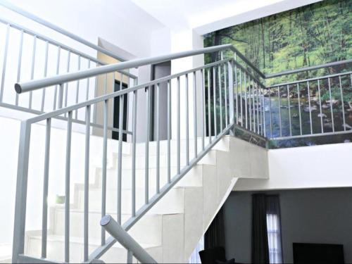 a staircase in a building with a painting on the wall at El-Gibbor Residence 1 in Ermelo