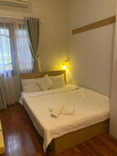 a bedroom with a bed with two towels on it at Lu Peaceful Homestay in Da Nang