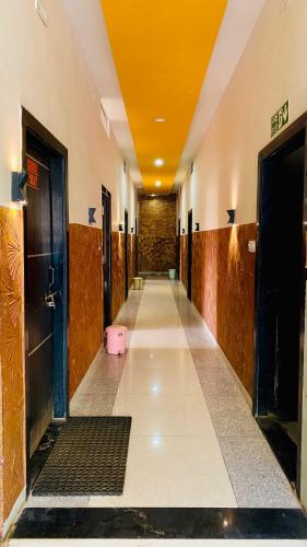 a hallway with a pink toilet in a building at Hotel Palash in Godarpura