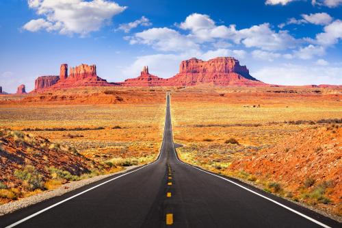 an empty road in the desert with red rocks at Gorgeous Historic 3 BR Log Cabin w Forest Views 20 Minutes from Flagstaff Now with Wi-Fi in Parks