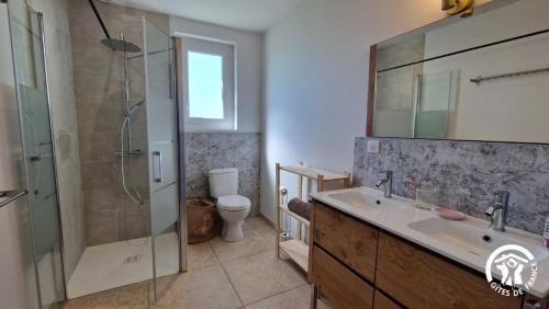 a bathroom with a shower and a sink and a toilet at La maison de prat coutel in Labastide-de-Lévis