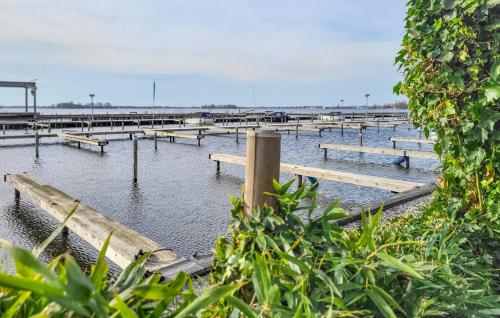 a row of benches in the water near a pier at Woonboot De Karekiet in Loosdrecht