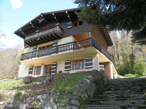a house on a hill with stairs in front of it at Chalet Franclair in Samoëns