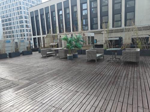 a patio with benches and tables in front of a building at Atour X Hotel West Nanjing Road in Shanghai