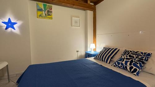 Un dormitorio con una cama con un edredón azul. en Mazara Relax Holiday Home, en Mazara del Vallo