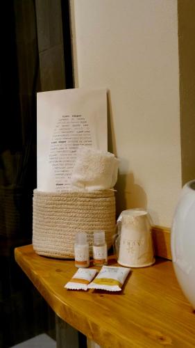a table with a box of towels and two bottles of medicine at Agada Suite in Aci Castello