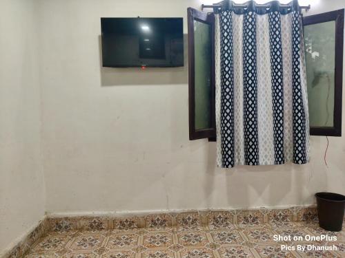 a wall with two windows and a tiled floor at Annamaiah Guest House & Homestay - Tirupati - Home Food Service in Tirupati