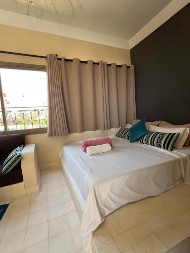 a bedroom with two beds and a window at SurfAppart Morocco in Tamraght Ouzdar