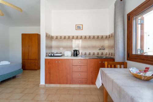 a kitchen with a counter and a table in a room at Maria Apartments in Pefki Rhodes
