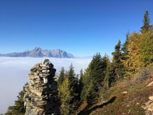 a stack of rocks on a mountain overlooking the ocean at Landhof Unterkreuter in Zwickenberg