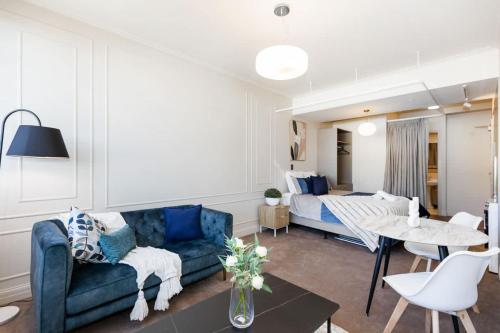 a living room with a couch and a bed at Cityview Studio - Heart of Te Aro - Sleeps 2 in Wellington