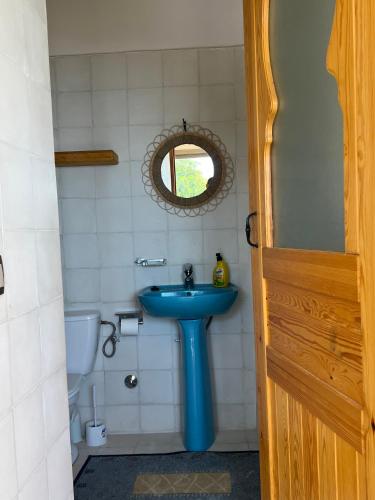a bathroom with a blue sink and a toilet at SurfAppart Morocco in Tamraght Ouzdar