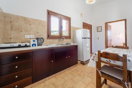 a kitchen with a sink and a refrigerator at Maria Apartments in Pefki Rhodes