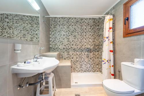 a bathroom with a sink and a toilet and a shower at Maria Apartments in Pefki Rhodes