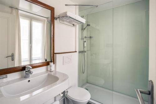 a bathroom with a sink and a toilet and a shower at Best Western Aramis Saint Germain in Paris