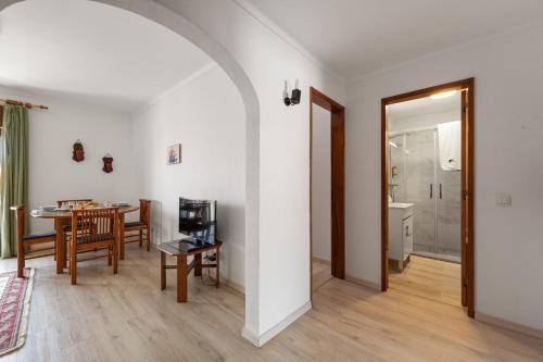 a living room with a table and a dining room at BmyGuest - Sesimbra Central Apartment in Sesimbra