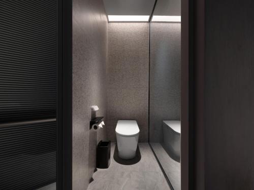 a bathroom with a toilet and a sink at Intercity Hotel South Central Taiyuan in Taiyuan