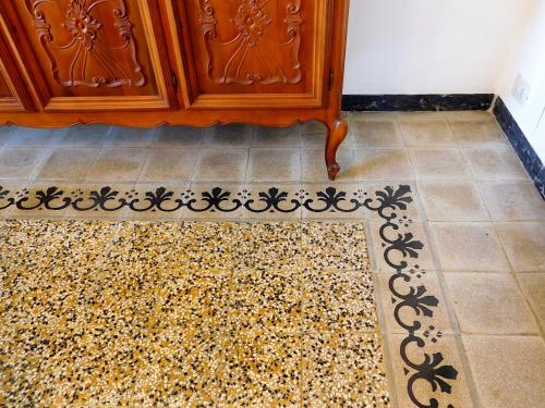 a room with a wooden cabinet and a rug at La mia casa sul mare, Levanto in Levanto