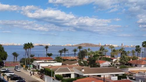 a view of a city with palm trees and the water at Amanecer en Cristal in Cartagena
