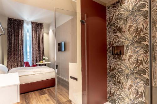 a bedroom with a bed and a glass shower at Calepina Alpine Suite in Trento