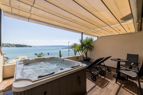 a hot tub in a balcony with a view of the ocean at Sea View Luxury Rooms Seven of Nine in Split