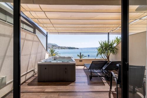 a view from the balcony of a house with a hot tub at Sea View Luxury Rooms Seven of Nine in Split