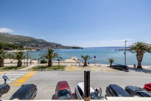 a parking lot with cars parked next to the water at Sea View Luxury Rooms Seven of Nine in Split