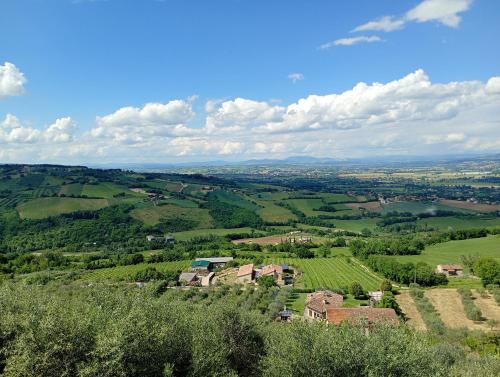 a view of a village in a green field at L'angolo delle More in Monte Castello di Vibio