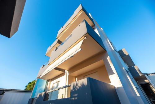 a building with a blue sky in the background at DreamCoast Apartments I in Artemida