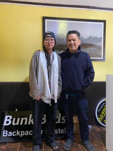 a man and a woman standing next to each other at Mellow Fellow Hostel Darjeeling in Darjeeling