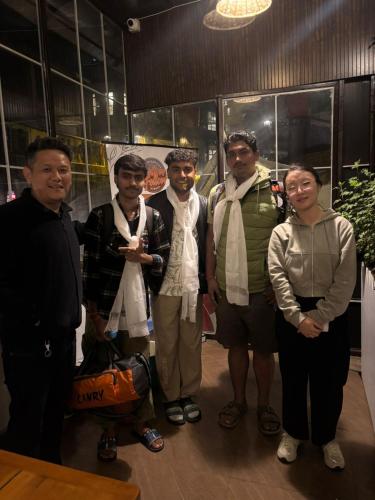 a group of people posing for a picture at Mellow Fellow Hostel Darjeeling in Darjeeling