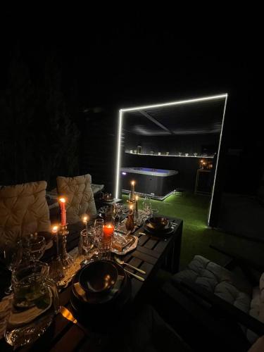 a table with candles and glasses on it at night at Bahnhofsoase - Wellness & Spa am Krufter Bahnhof in Kruft