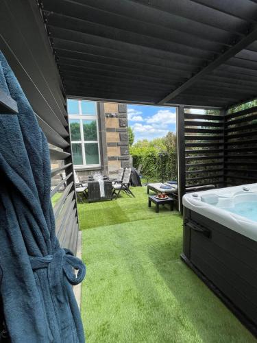 a bathroom with a bath tub in a yard at Bahnhofsoase - Wellness & Spa am Krufter Bahnhof in Kruft