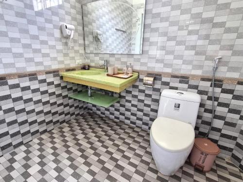 a bathroom with a toilet and a sink at Top Hill Halong in Ha Long