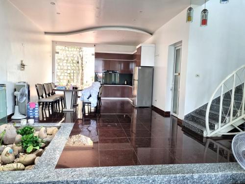 a living room with a kitchen and a dining room at Top Hill Halong in Ha Long