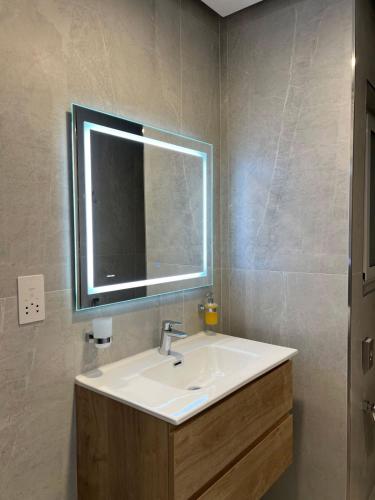 a bathroom with a sink and a mirror at Bay Seafront Apartment in Marsaskala
