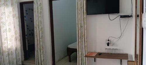 a room with a mirror and a television on a wall at Nature Hike in Lansdowne