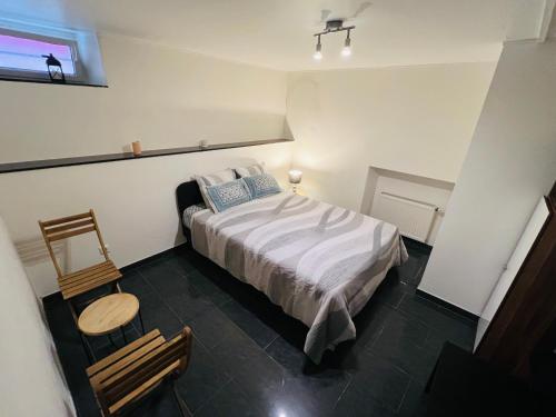 a small bedroom with a bed and a chair at Private 1-Bedroom Apartment in Dudelange Centre in Dudelange