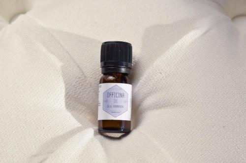 a bottle of medicine sitting on a white blanket at Domus Aromatica in Assisi